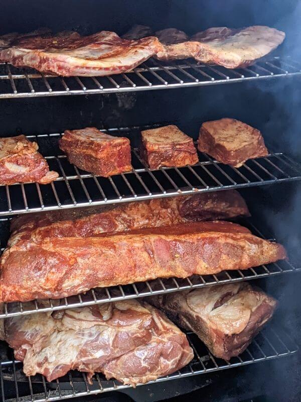 https://cheftravelguide.com/wp-content/uploads/2022/05/smoked-meats-in-smoker.jpg